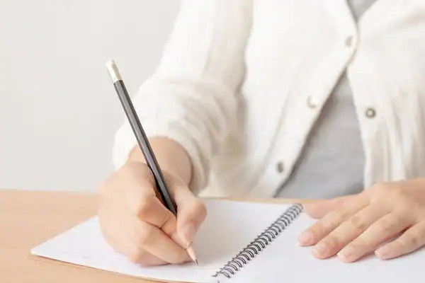 depositphotos_403692872-stock-photo-female-hand-pencil-writing-blank